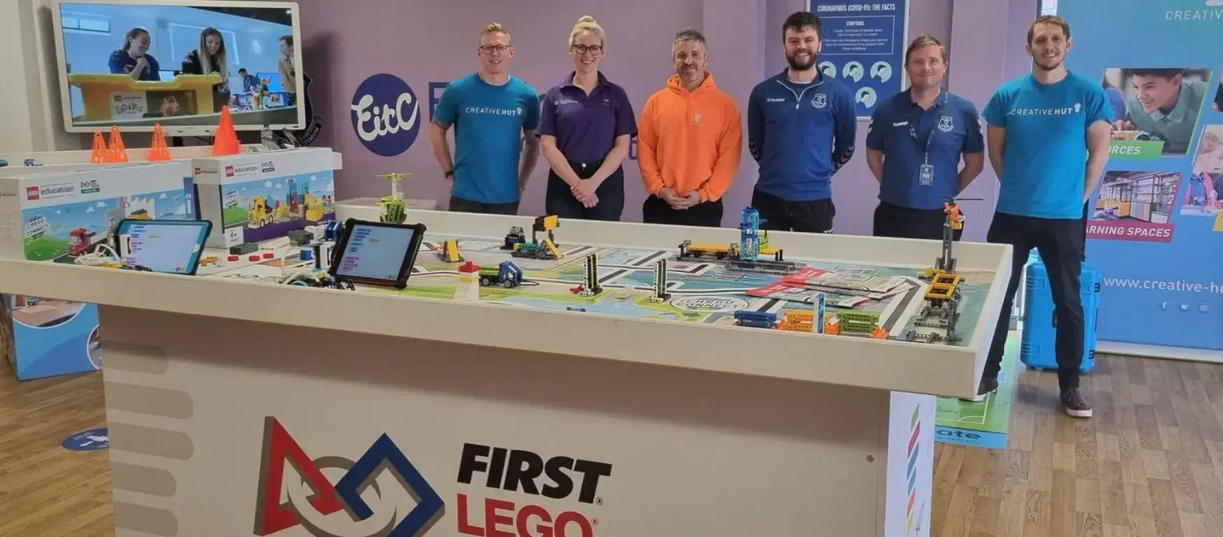 Group of educators showcasing FIRST LEGO resources at EFDN conference in Liverpool.