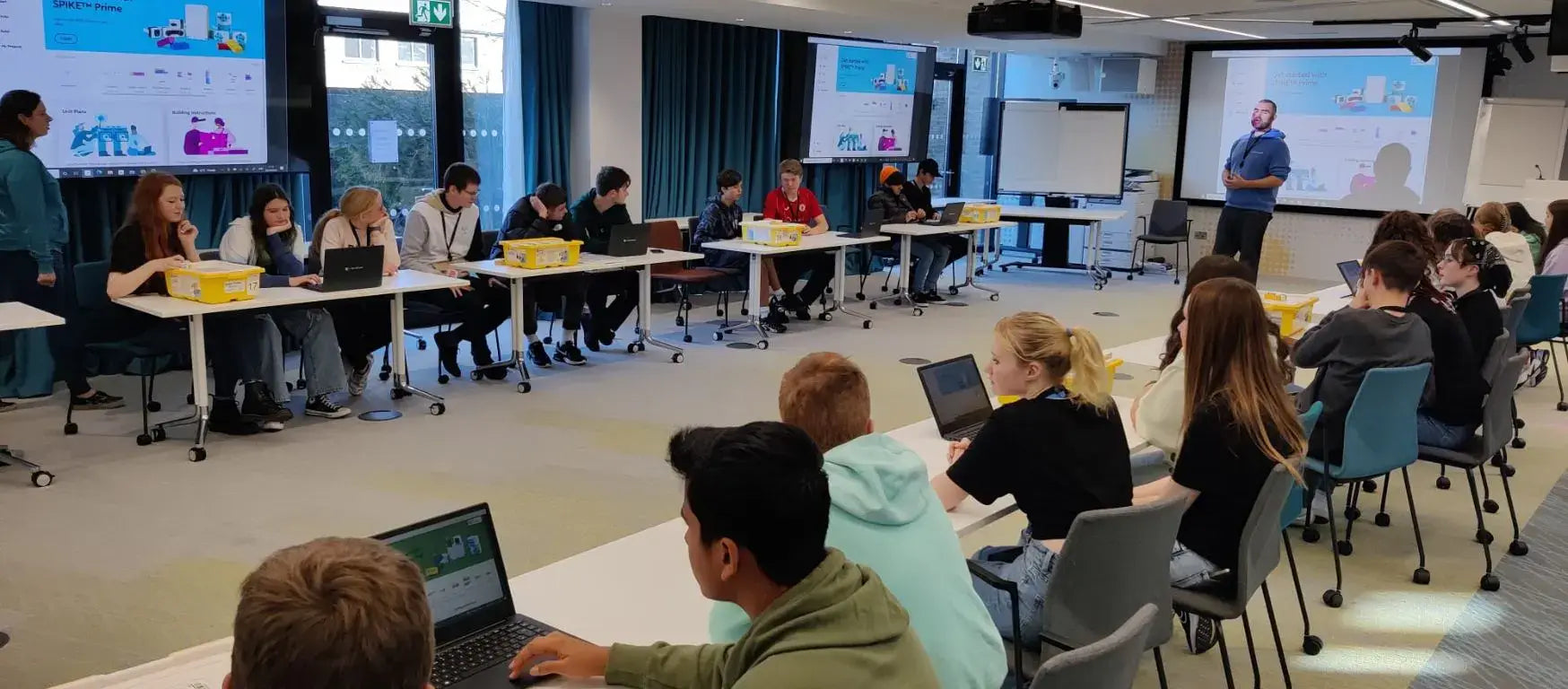 Students participating in a Creative Hut workshop at Google's Dublin office, engaged and collaborating around tables.