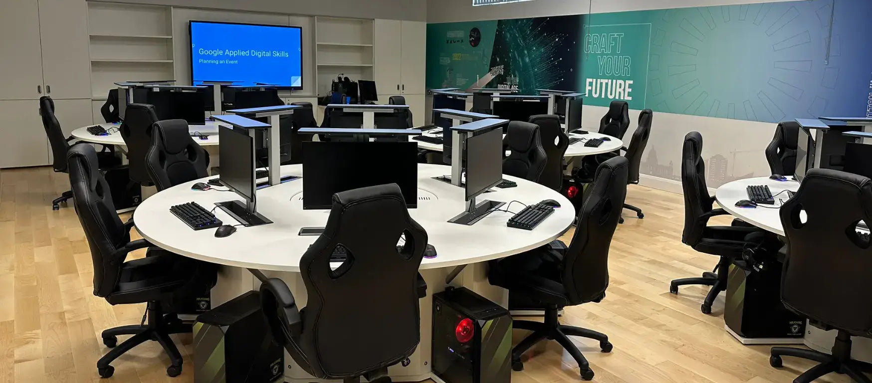 Modern esports lab with computers and ergonomic chairs, designed for immersive digital learning experiences.