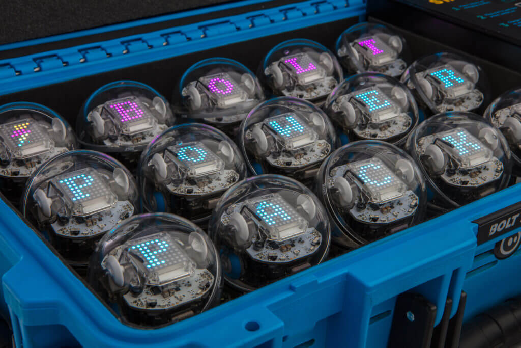 Array of robotic power packs in a blue case, each displaying colorful letters, showcasing innovative technology.