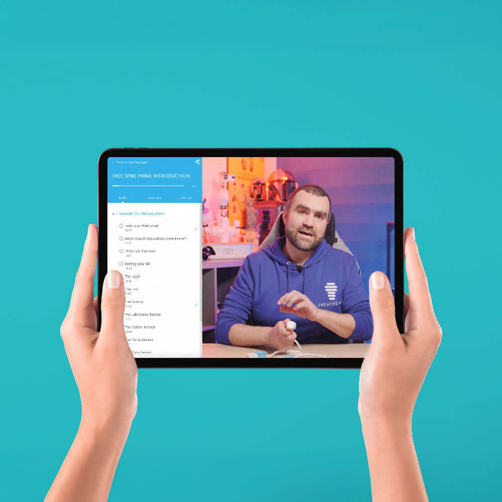 Person presenting a video tutorial on a tablet, hands holding the device against a bright blue background.