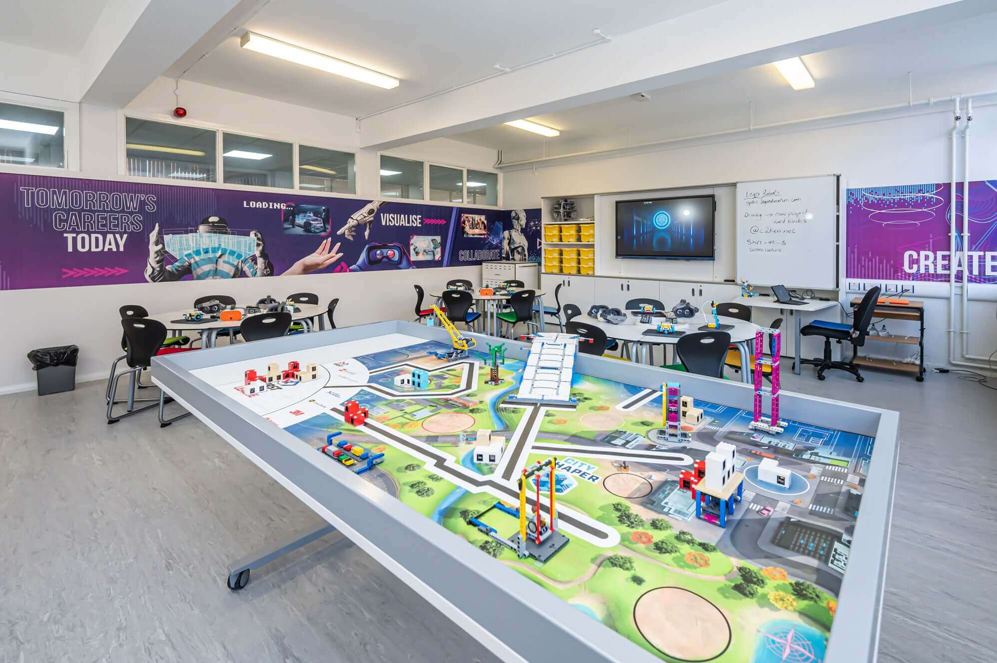 A modern classroom with a hands-on learning table, showcasing models for STEM education and innovative technology.
