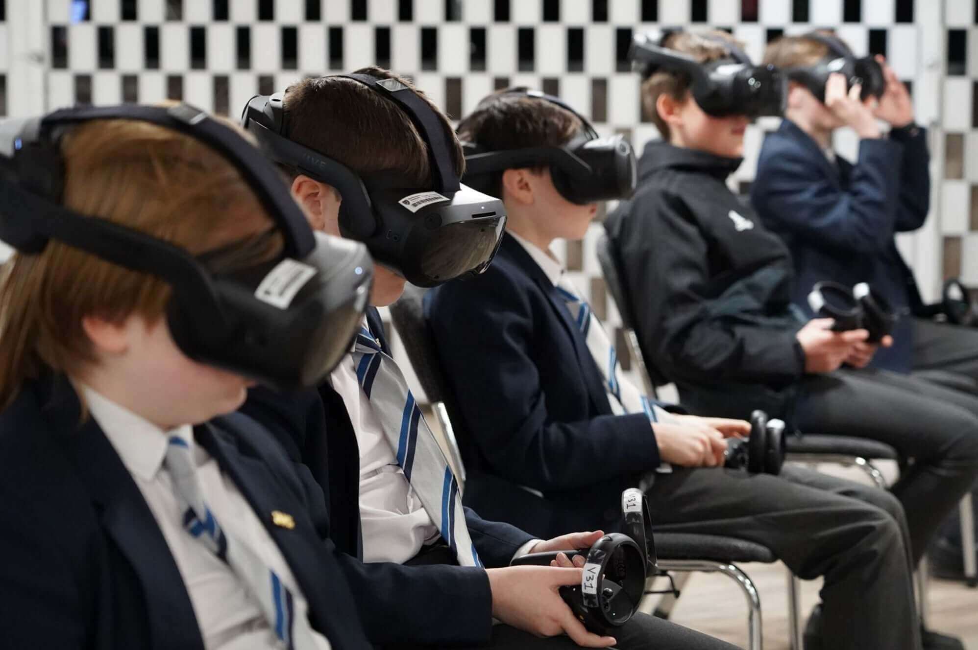 Students wearing VR headsets, engaging with virtual reality technology in a classroom setting.