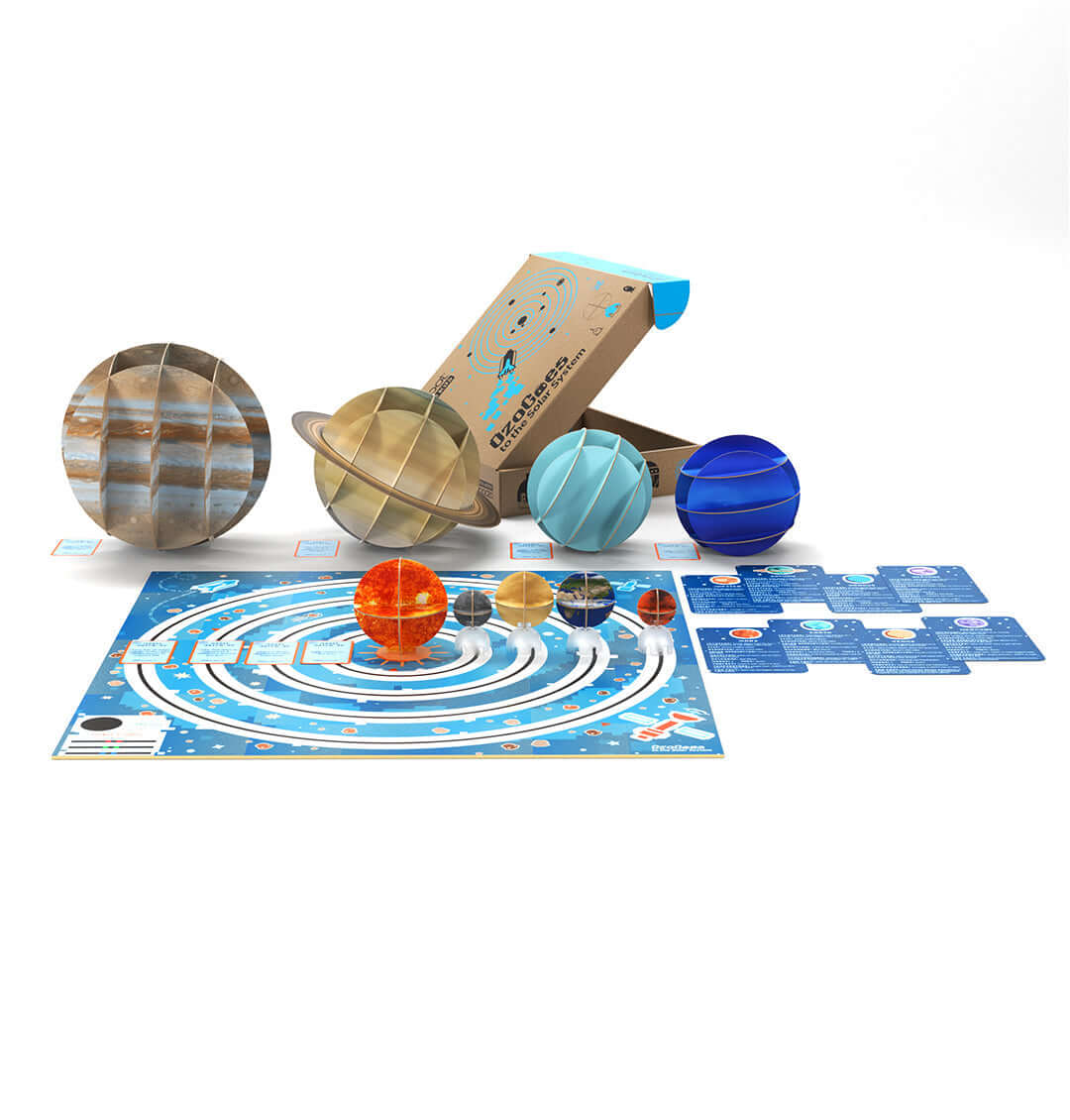 OzoGoes to the Solar System kit featuring colorful planet models and a spiral game board for educational STEAM activities.