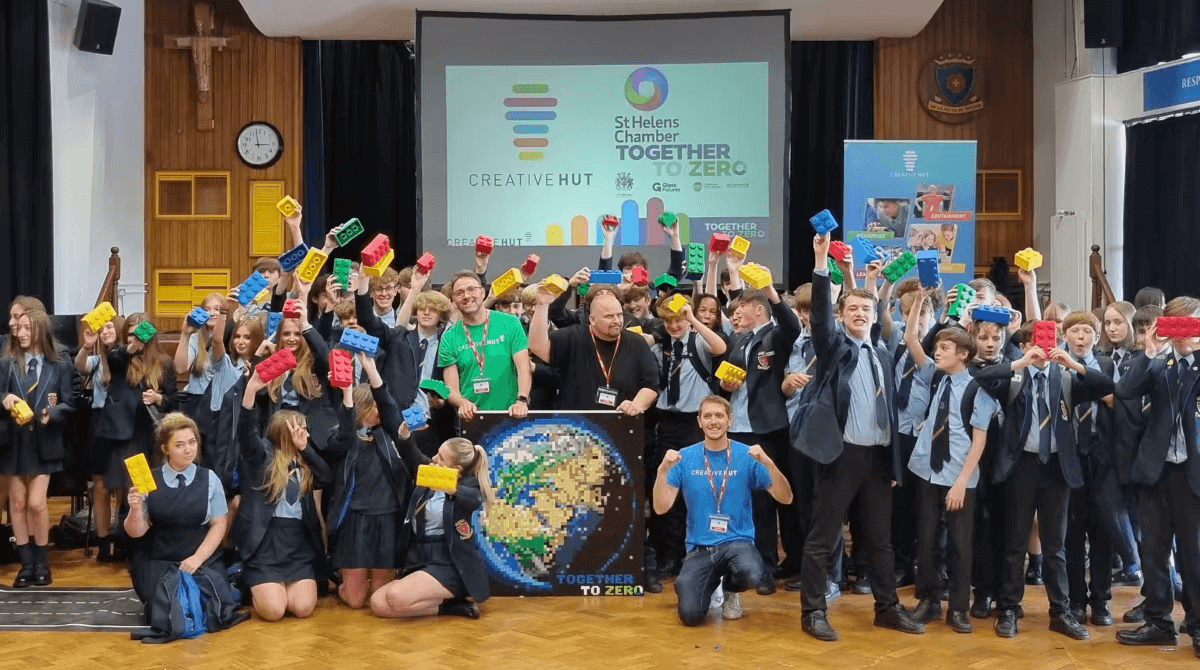 Students and facilitators celebrating Together To Zero initiative at St Helens Chamber with colorful building blocks.