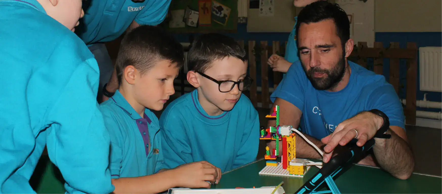 Beaver Scouts engage with LEGO® Education SPIKE™ Essential with a mentor during a coding workshop.