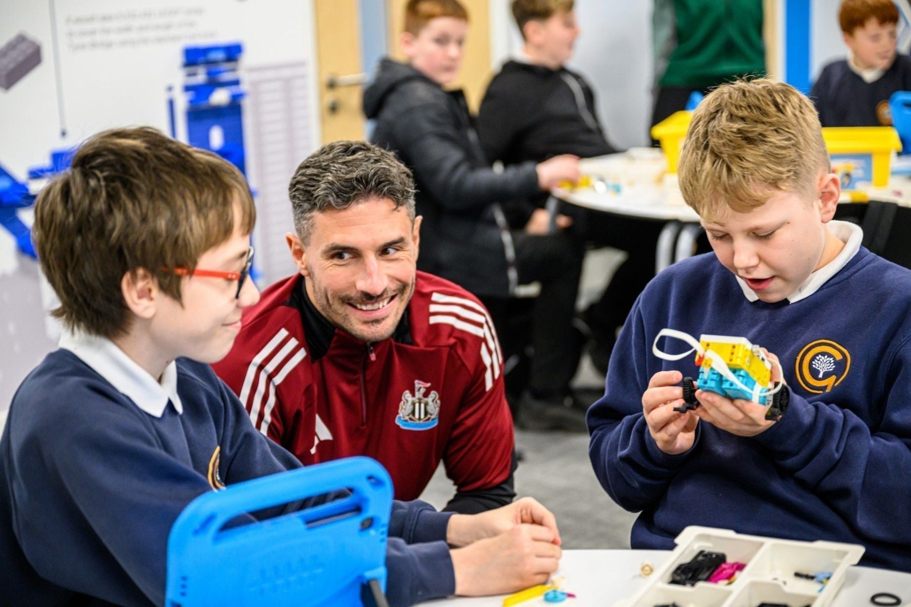 Students engage in a STEM project with a mentor at the Newcastle United Foundation's learning room.