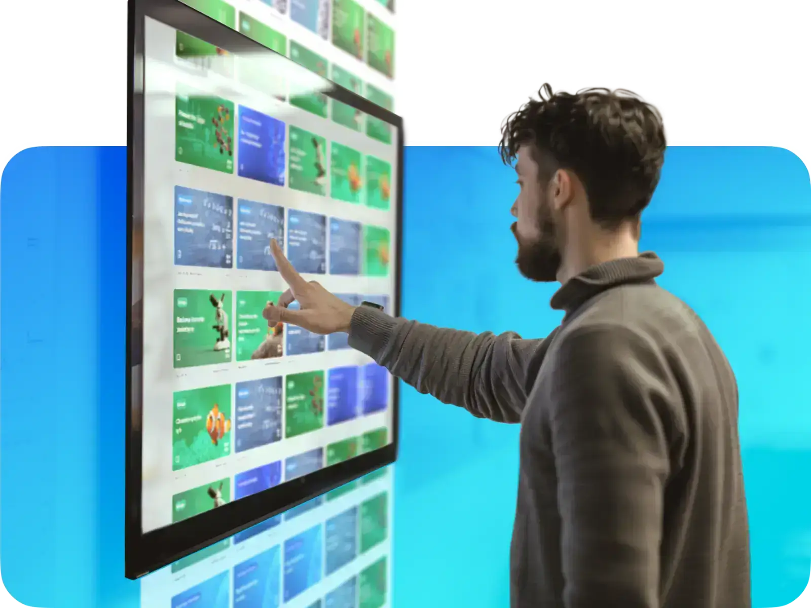 A man interacting with a touchscreen display, exploring colorful digital content and graphics.