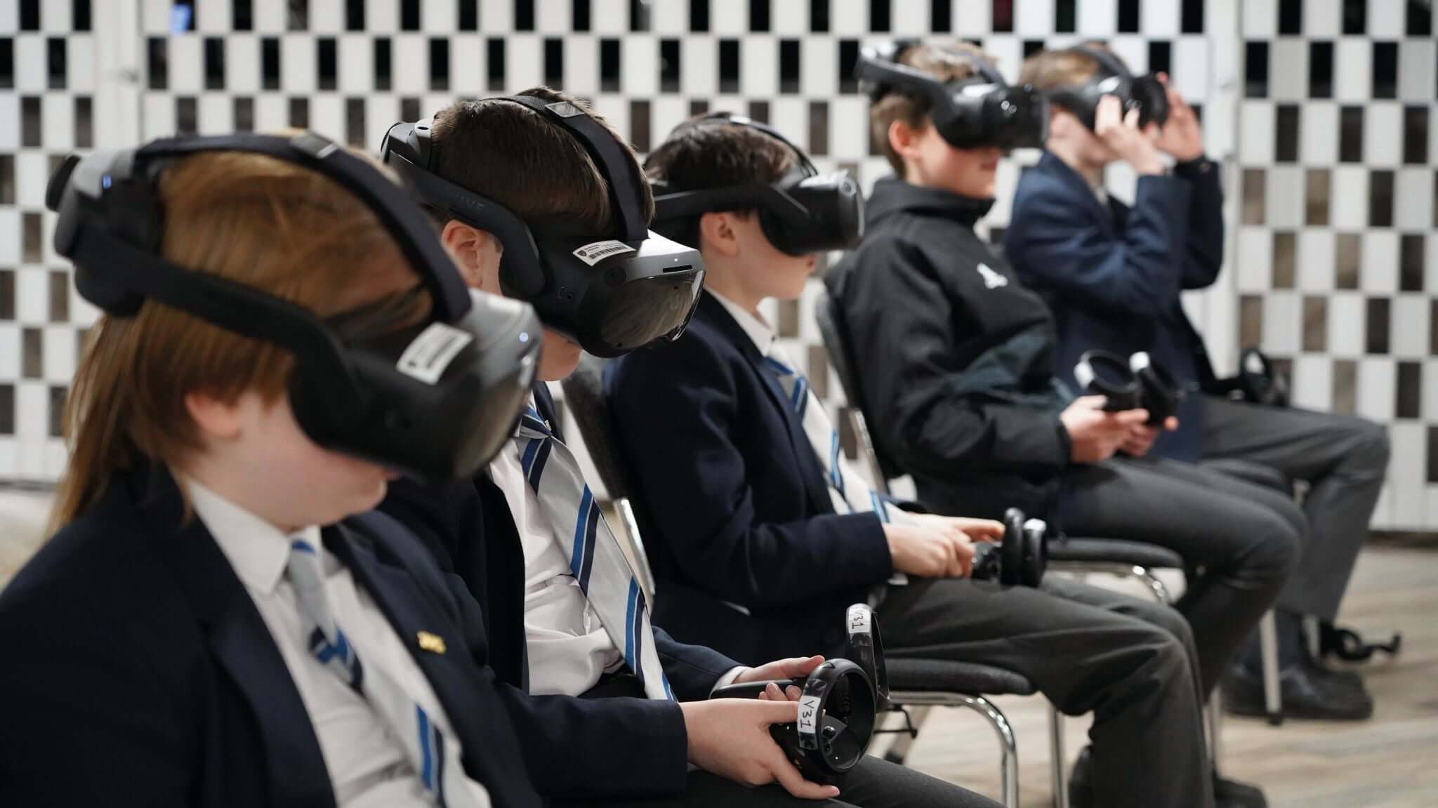 Students wearing VR headsets engaged in virtual reality experience during a technology event.