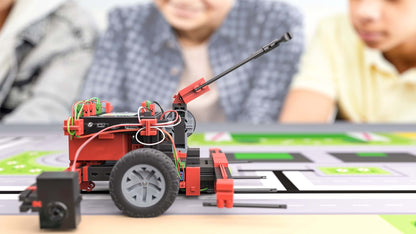 A close-up of the STEM Coding RoboMission robotics construction kit being used on a mat by children.