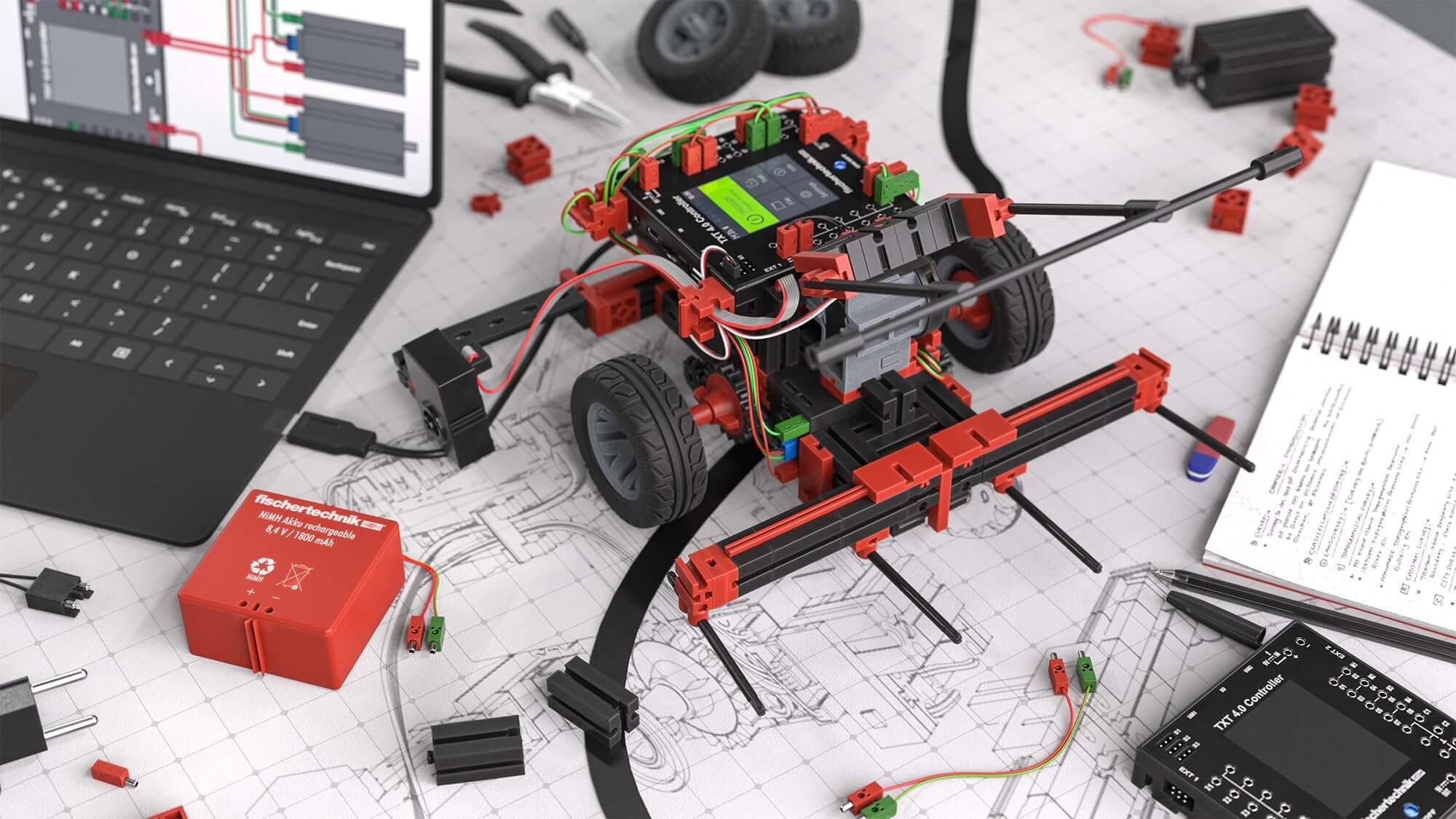 STEM Coding RoboMission robotics construction kit on a workspace with laptop and design schematics.