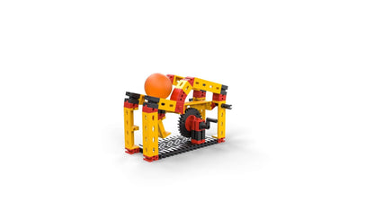 Colorful model of simple machines for teaching physics in primary schools, featuring gears and an orange ball.