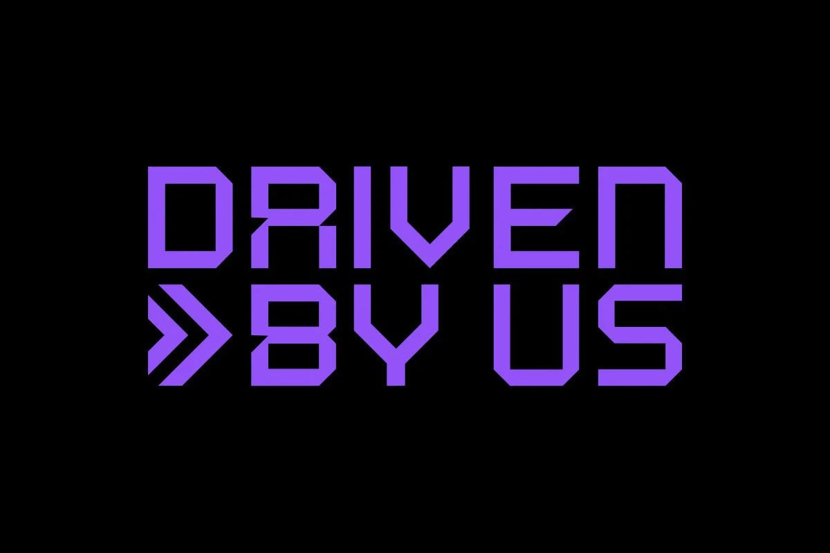 Graphic design featuring the phrase 'DRIVEN BY US' in purple text on a black background.