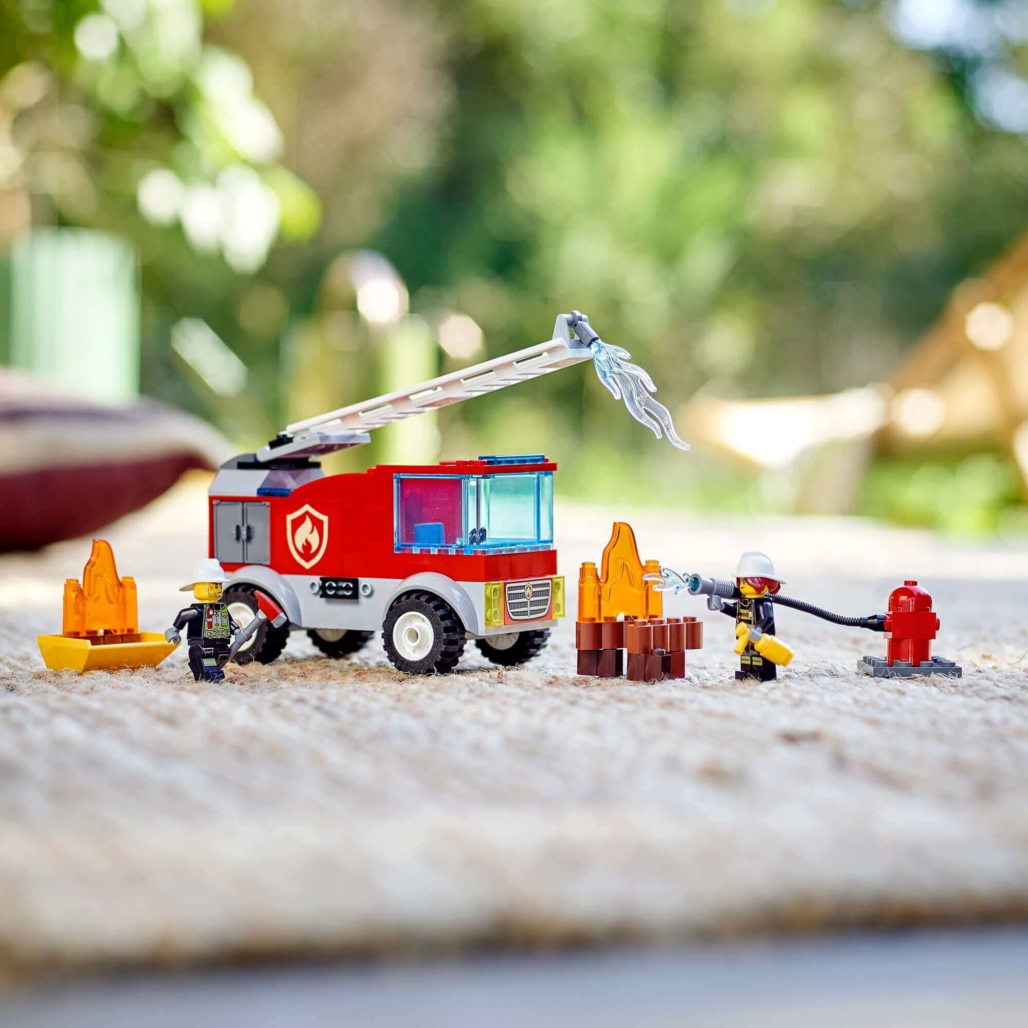 LEGO City Fire Ladder Truck 60280 set featuring Freya McCloud and firefighters with flames on a play mat.