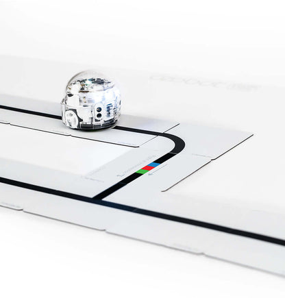 Ozobot Colour Code Magnet Base Kit with Evo robot on a magnetic board, teaching coding concepts for young learners.
