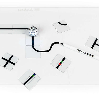 Ozobot Base Kit with magnetic board, wet erase marker, and color code puzzle pieces for coding education.