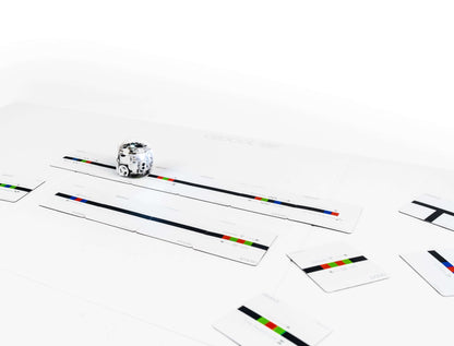 Ozobot Colour Code Magnets with coding puzzle pieces, showcasing an Evo robot on a learning board.
